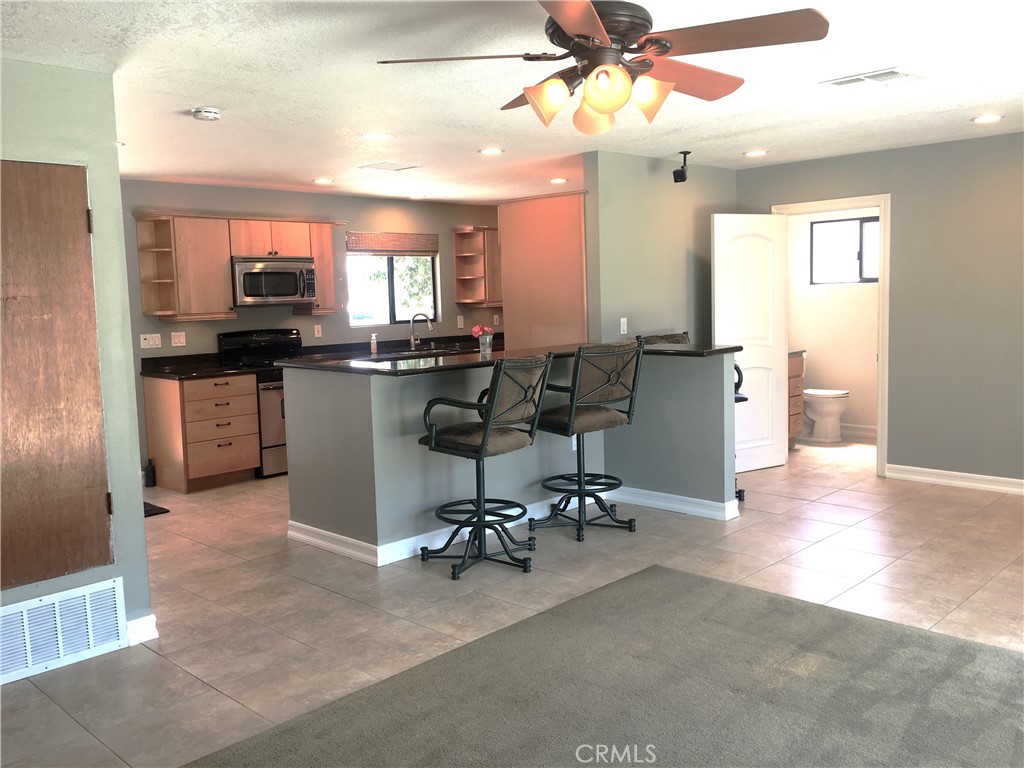 10011 Bernice Circle Buena Park, CA 90620 - Photo 9 of 28 a view of a kitchen with dining area a sink and a refrigerator