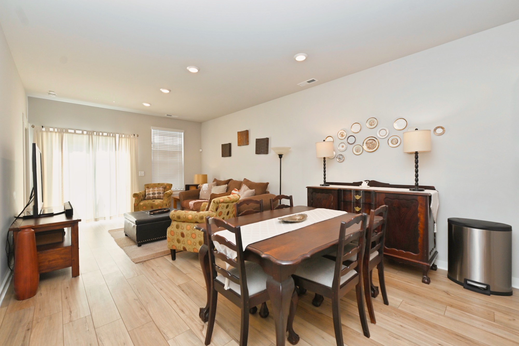 704 Mickelson Way Lebanon, TN 37087 - Photo 13 of 38 a view of a a dining room with furniture window and wooden floor