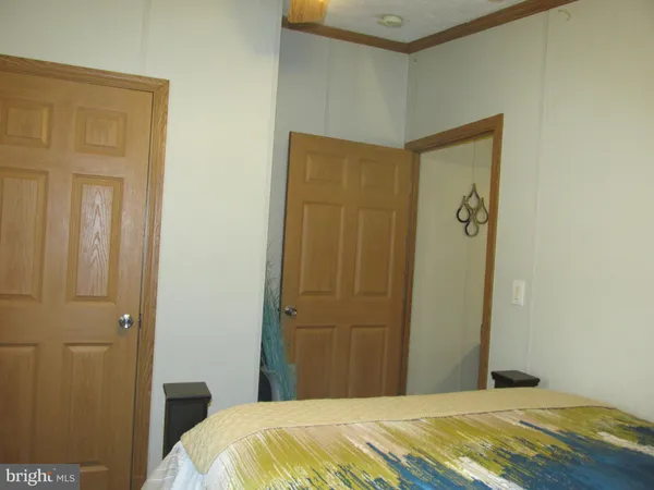 a bedroom with a bed and a mirror