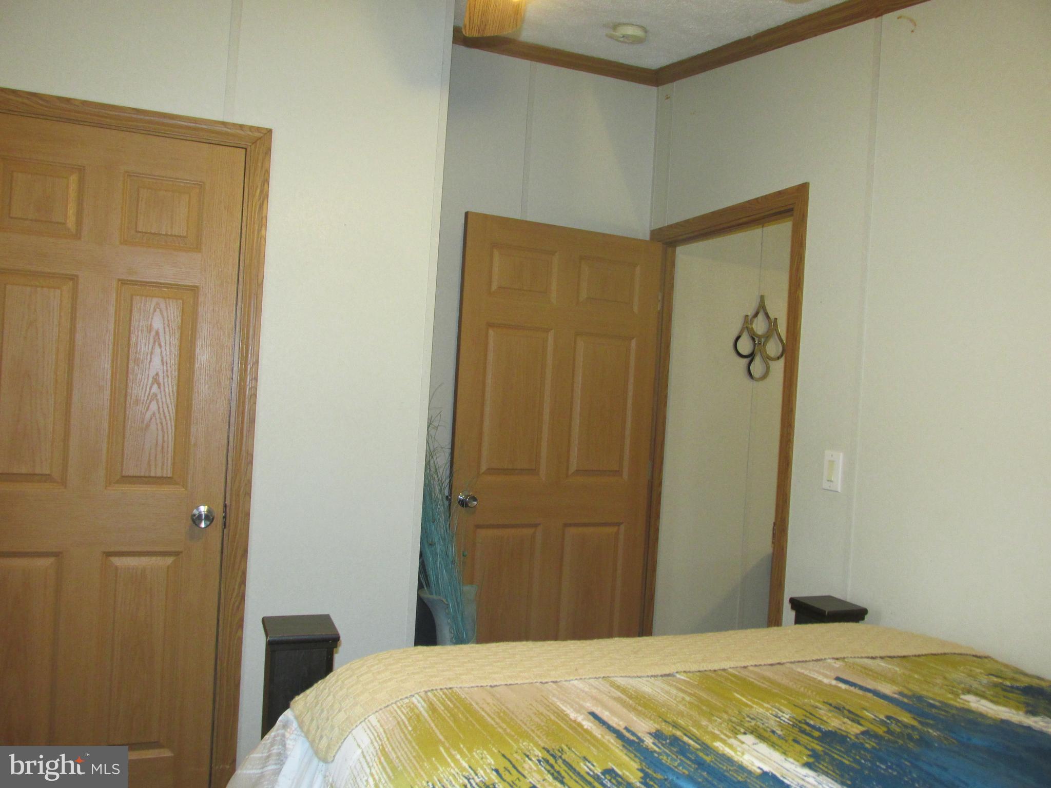 6539 Cabin Ridge Road Hurlock, MD 21643 - Photo 12 of 31 a bedroom with a bed and a mirror