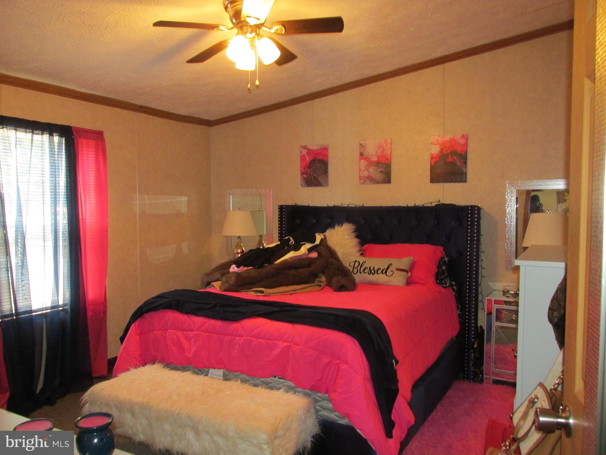 6539 Cabin Ridge Road Hurlock, MD 21643 - Photo 22 of 31 a bedroom with a bed and a chandelier