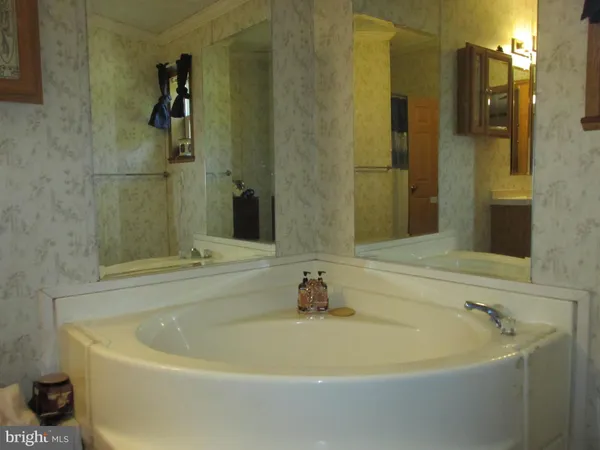 a bath tub sitting next to a bathroom sink