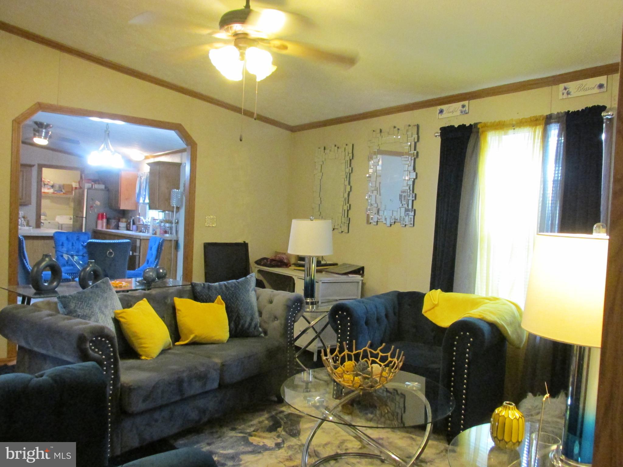 6539 Cabin Ridge Road Hurlock, MD 21643 - Photo 31 of 31 a living room with furniture and a chandelier