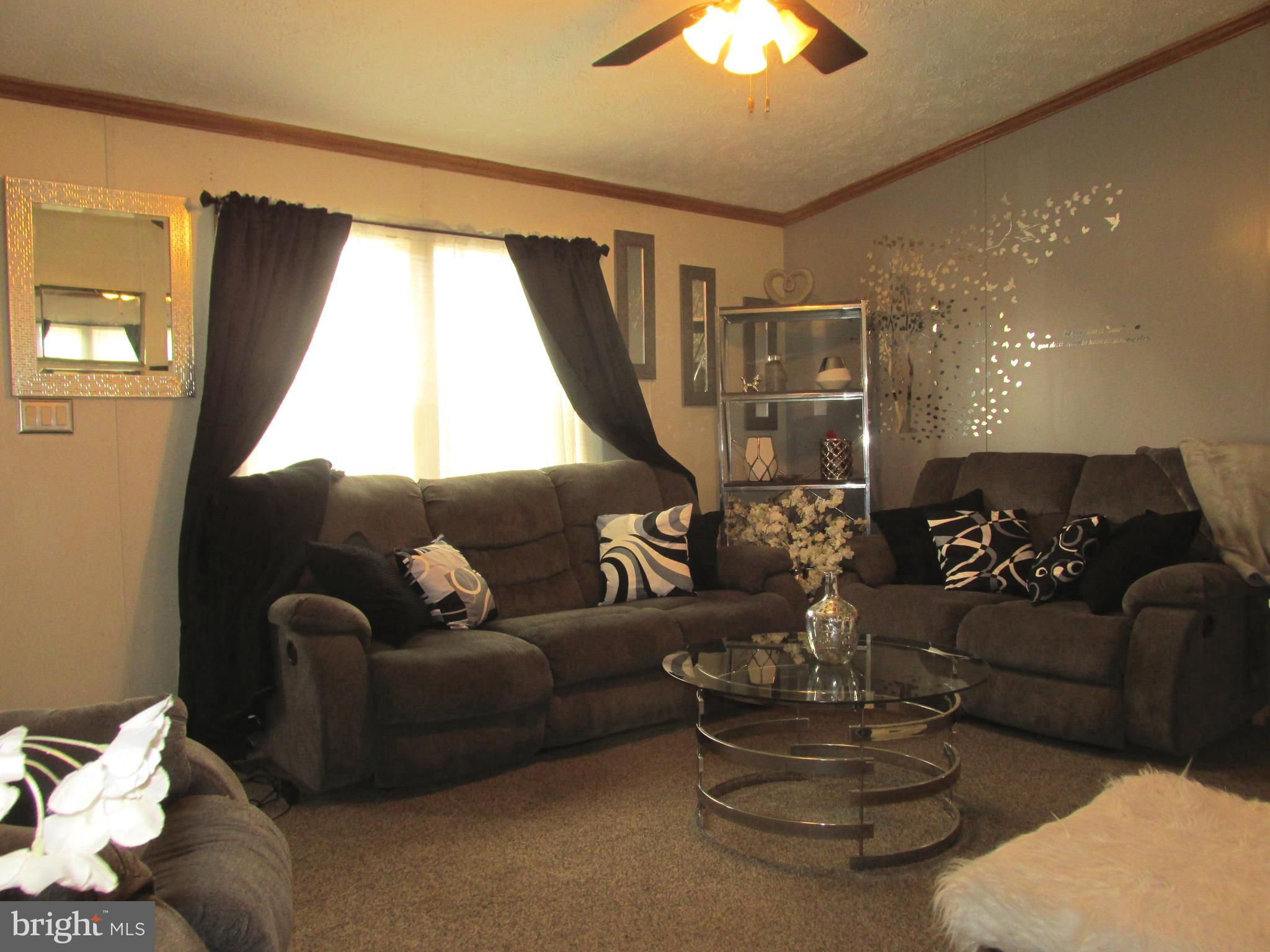 6539 Cabin Ridge Road Hurlock, MD 21643 - Photo 7 of 31 a living room with furniture and a large window