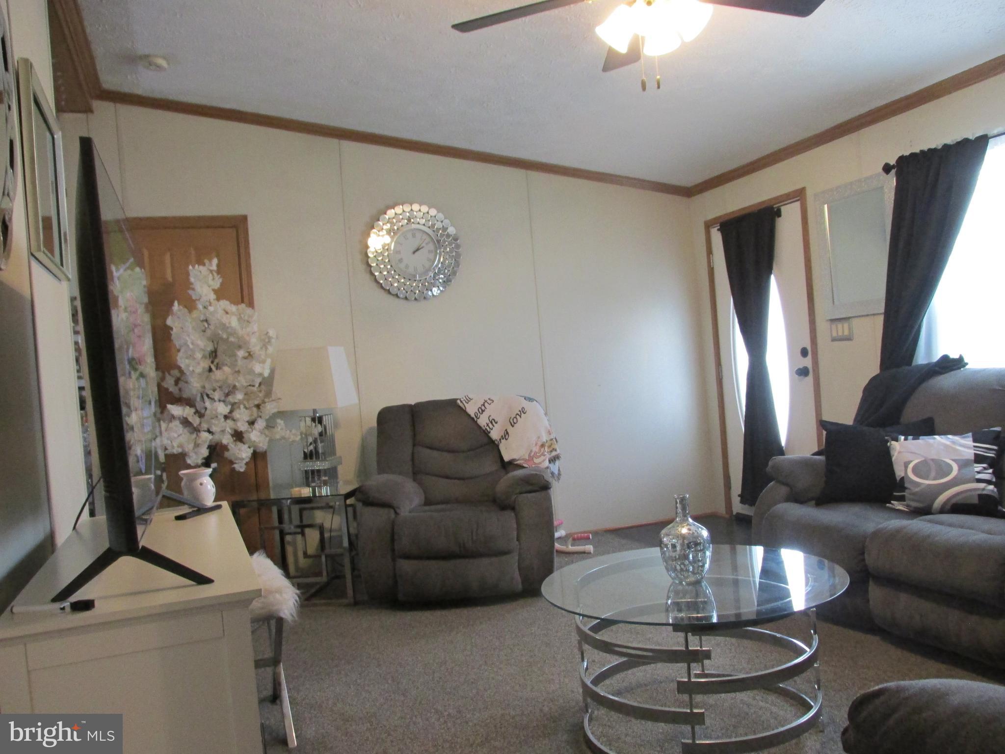 6539 Cabin Ridge Road Hurlock, MD 21643 - Photo 8 of 31 a living room with furniture and a chandelier