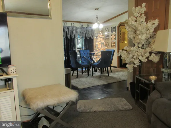 a view of a dining room with furniture and chandelier