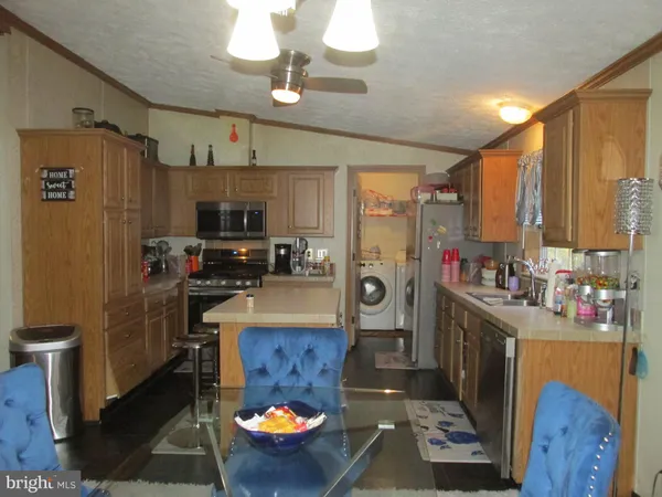 a kitchen with refrigerator and stove