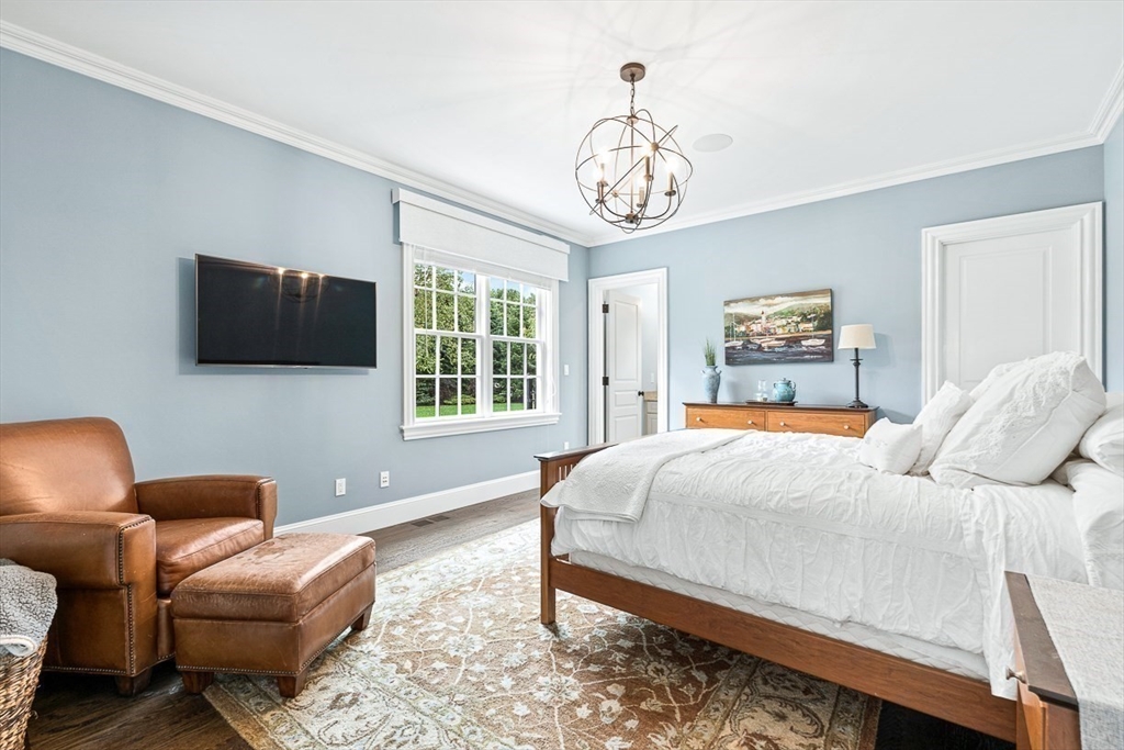 11 Village Lane Needham, MA 02492 - Photo 15 of 42 a bedroom with furniture and a flat screen tv