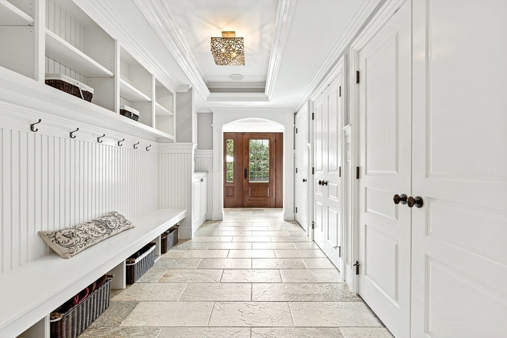 11 Village Lane Needham, MA 02492 - Photo 16 of 42 a hallway with a white stove and a wooden floor