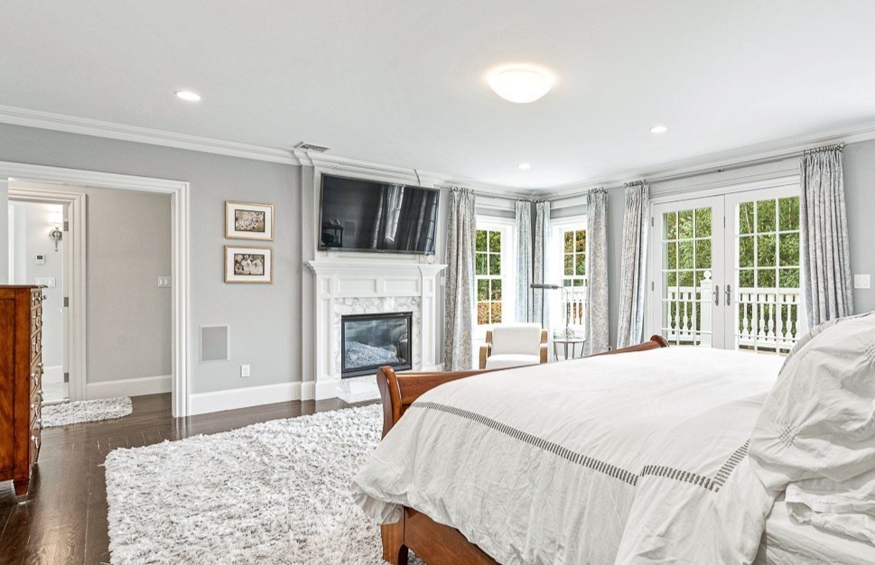 11 Village Lane Needham, MA 02492 - Photo 17 of 42 a spacious bedroom with a large bed and a flat screen tv