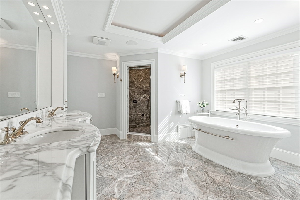 11 Village Lane Needham, MA 02492 - Photo 18 of 42 a spacious bathroom with a bathtub sink and mirror