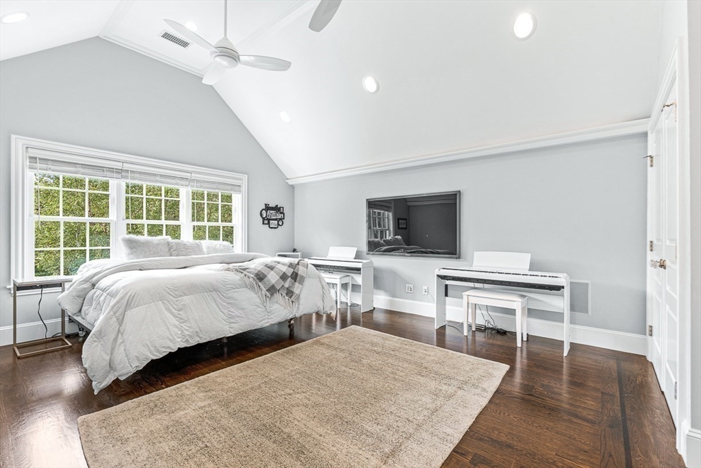 11 Village Lane Needham, MA 02492 - Photo 19 of 42 a bedroom with a bed and a flat screen tv