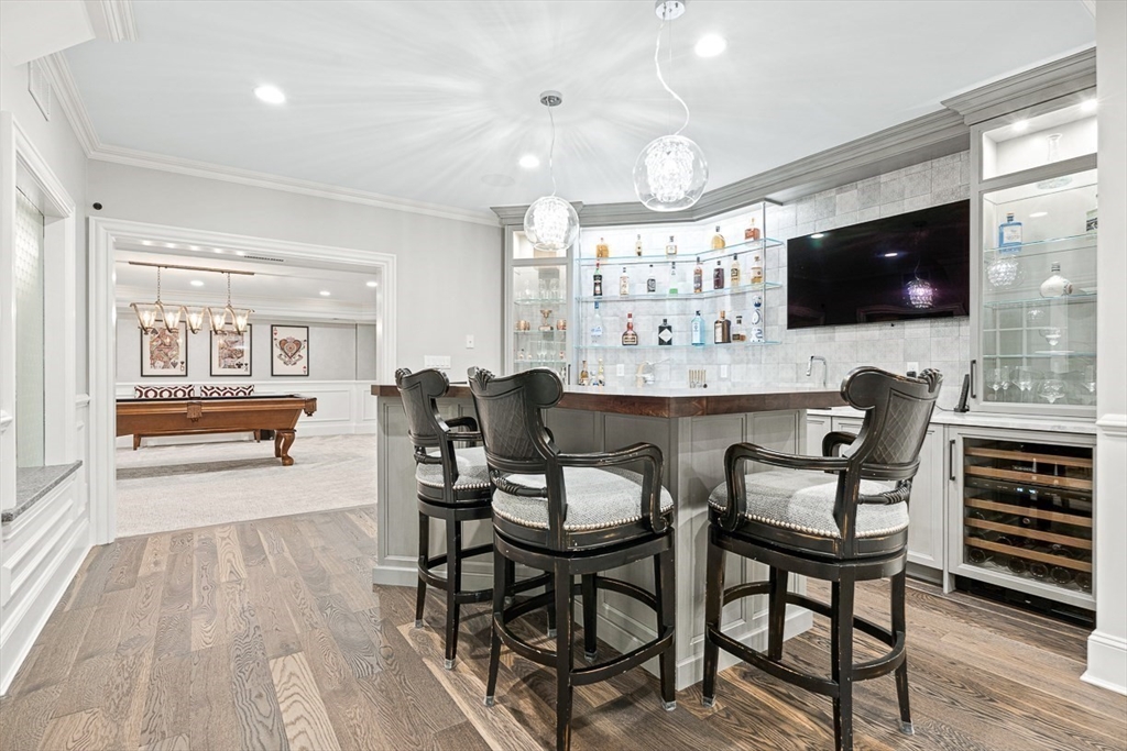 11 Village Lane Needham, MA 02492 - Photo 25 of 42 a living room with furniture and a flat screen tv