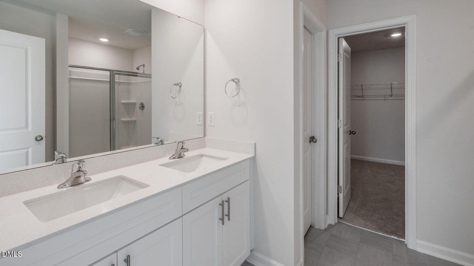 1261 Pavo Path Wendell, NC 27591 - Photo 17 of 40 a bathroom with a double vanity sink mirror and shower