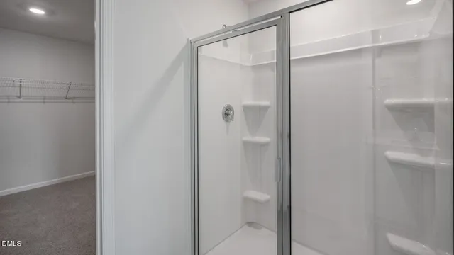 a bathroom with a sink toilet vanity and shower
