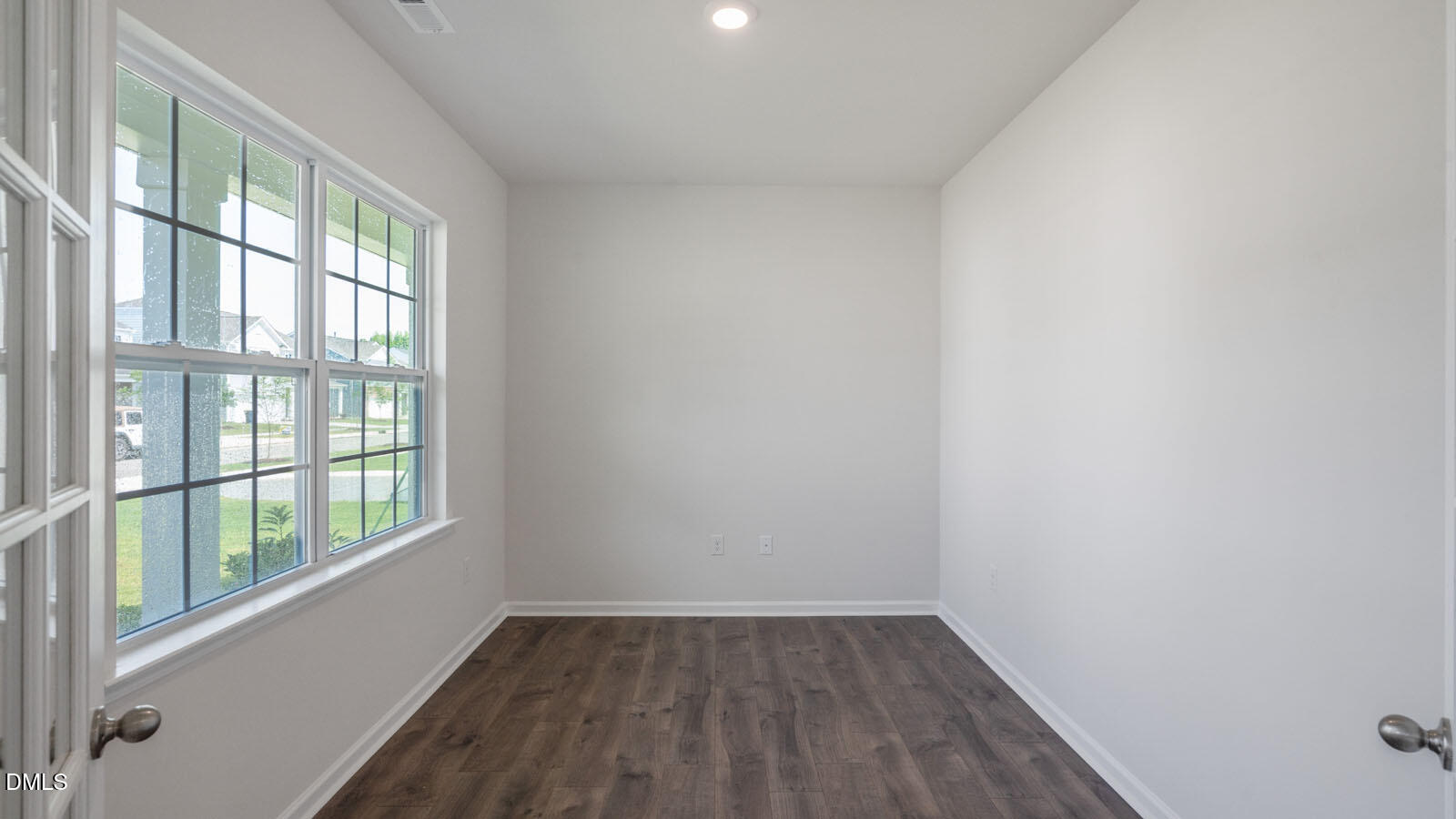 1261 Pavo Path Wendell, NC 27591 - Photo 3 of 40 a view of an empty room with wooden floor and windows