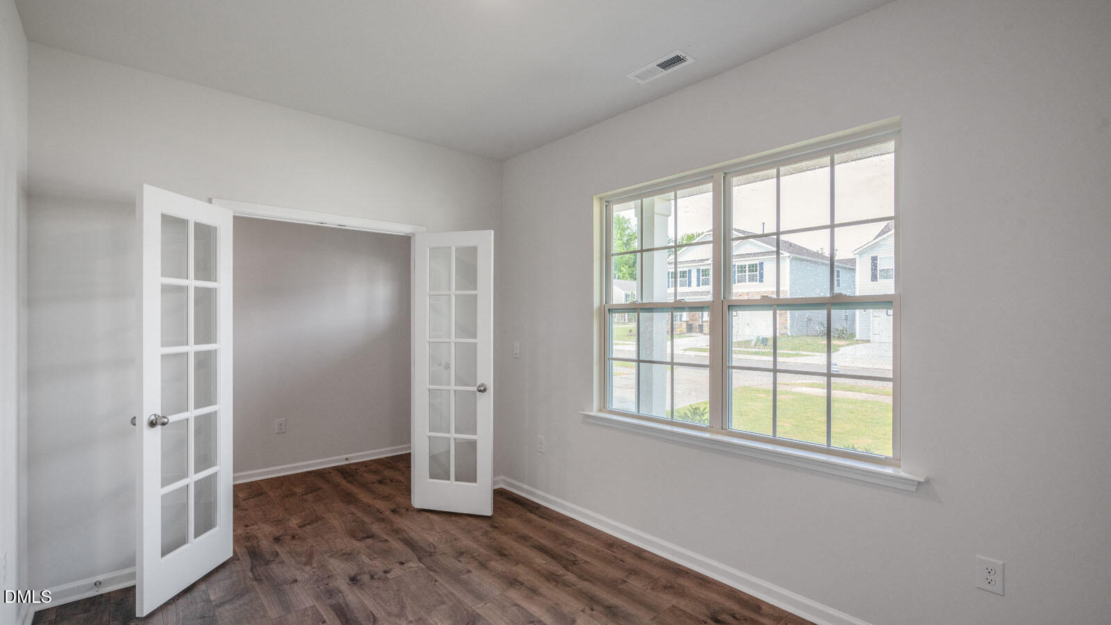 1261 Pavo Path Wendell, NC 27591 - Photo 4 of 40 a view of an empty room with wooden floor and a window
