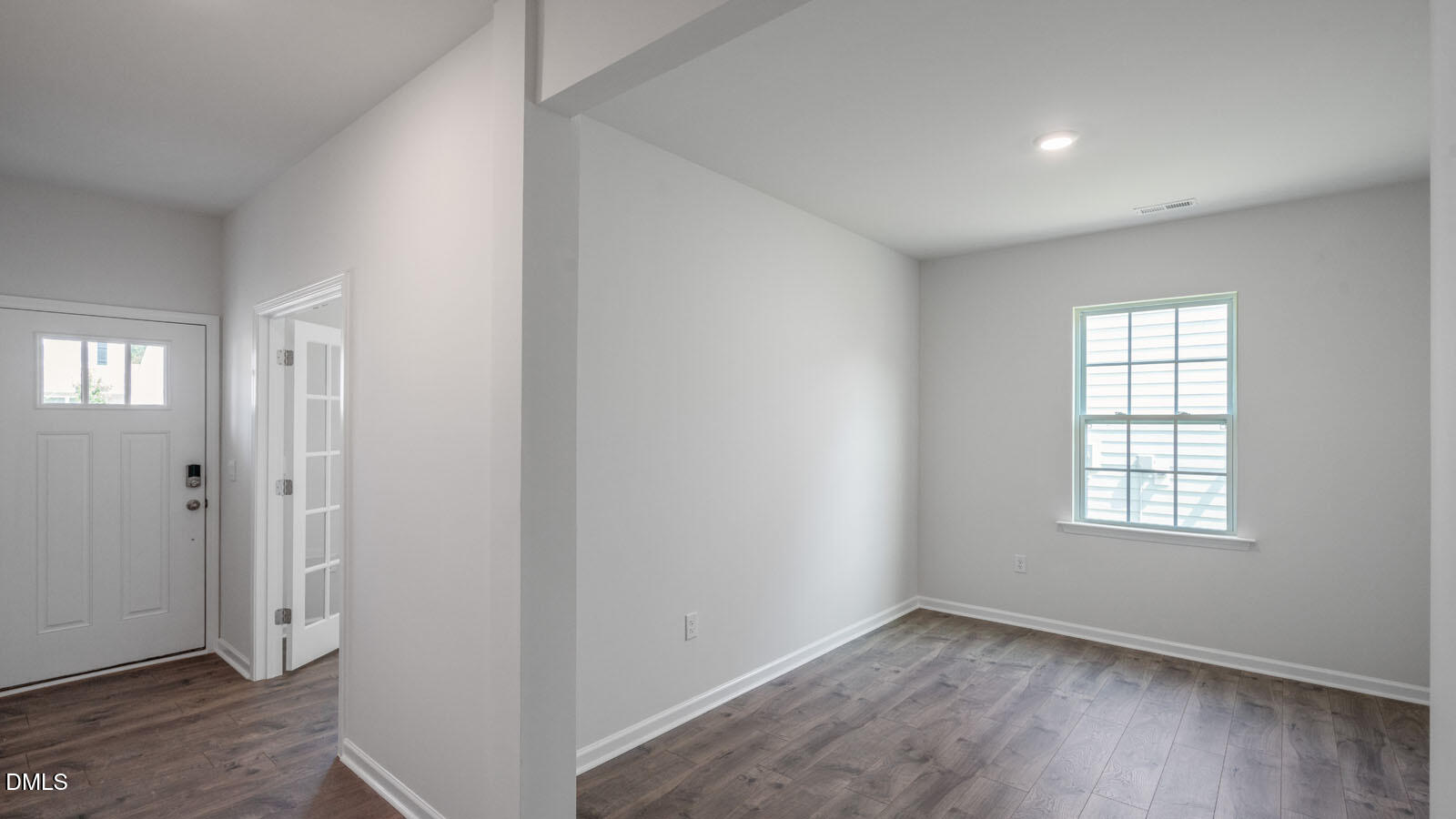 1261 Pavo Path Wendell, NC 27591 - Photo 5 of 40 a view of an empty room with wooden floor and a window
