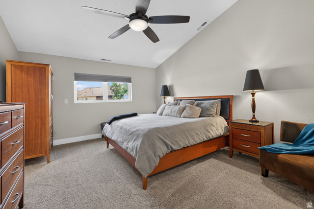 4297 Beeman Road Moab, UT 84532 - Photo 16 of 59 Spacious room featuring vaulted ceilings, a contemporary ceiling fan with integrated lighting, window with roller shade, and plush carpeting