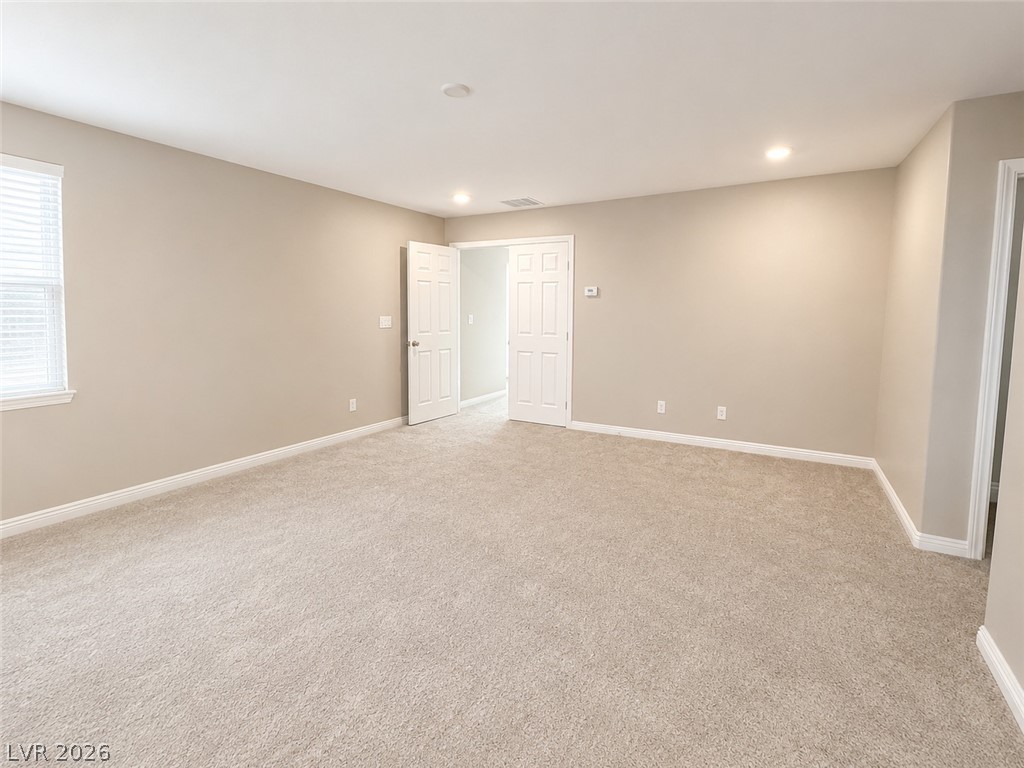8768 Rio Andir Avenue Las Vegas, NV 89148 - Photo 7 of 9 Ample floor space and well-lit interiors characterize this adaptable living area, perfect for any family's needs.