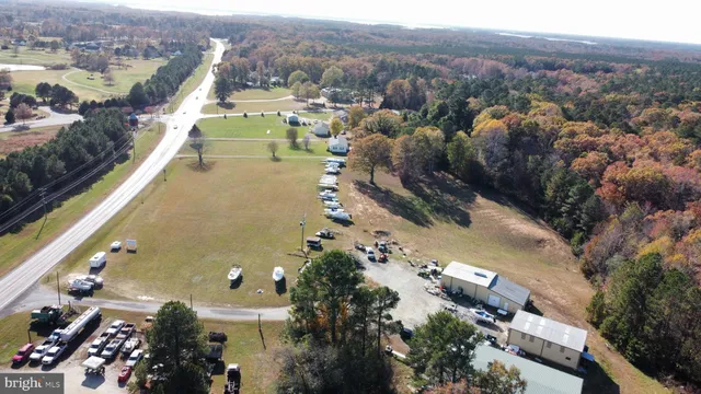an outdoor space with furniture and white umbrellas