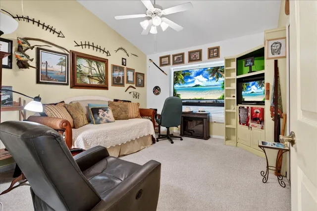 a living room with furniture a fireplace and a large window