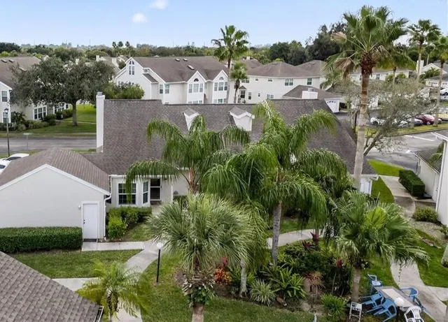 an aerial view of residential houses with outdoor space and seating space