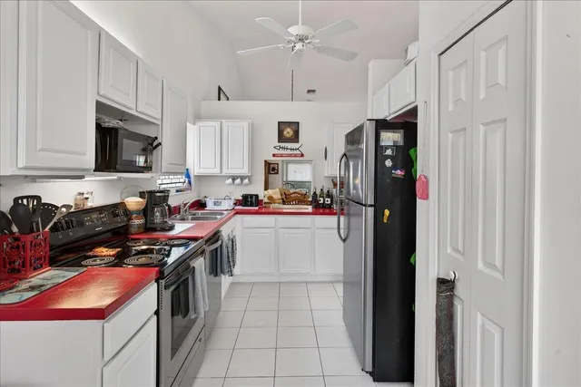 a kitchen with stainless steel appliances granite countertop a refrigerator and a stove
