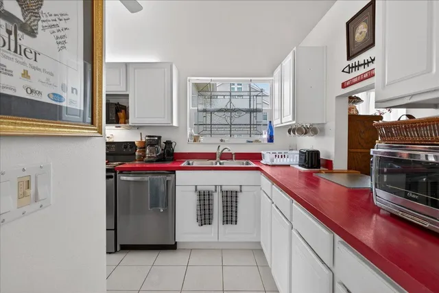 a kitchen with a sink cabinets and window