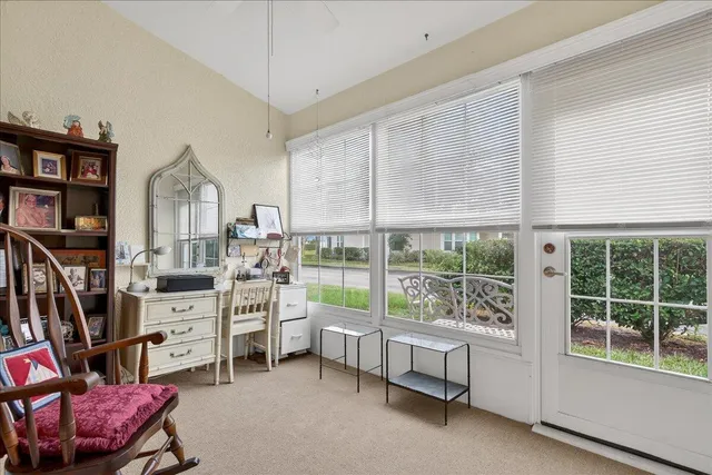 a view of a bedroom with furniture and windows