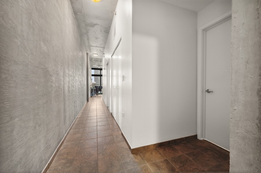 235 West Van Buren Street, Unit 1506 Chicago, IL 60607 - Photo 10 of 16 a view of a hallway with wooden floor