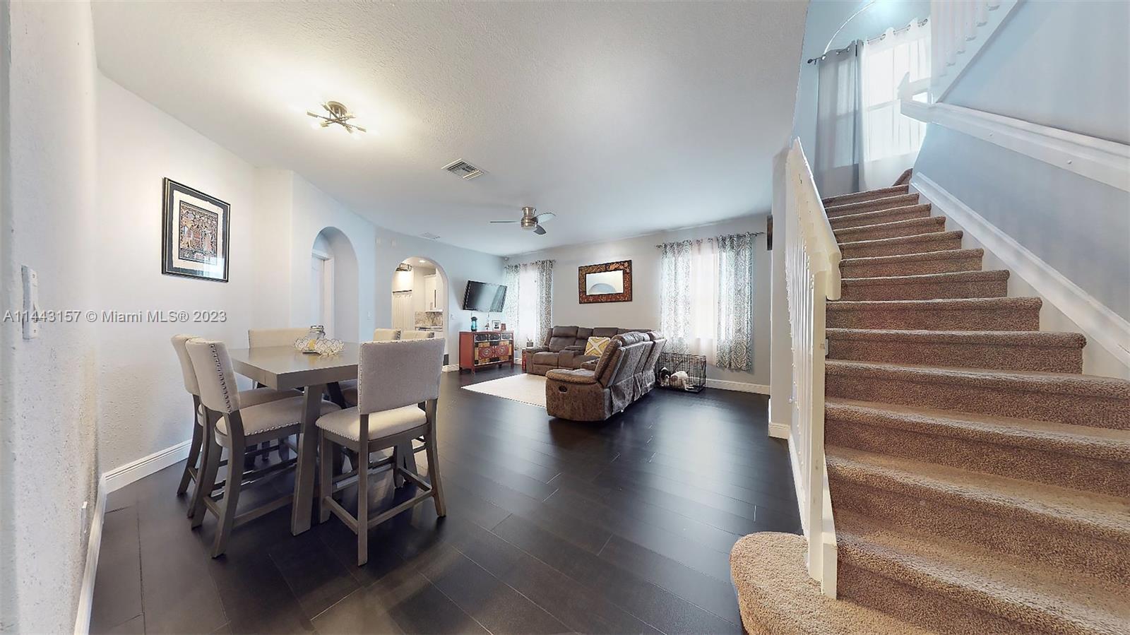 2231 Northeast 37th Road Homestead, FL 33033 - Photo 17 of 49 a living room with furniture and a dining table with wooden floor