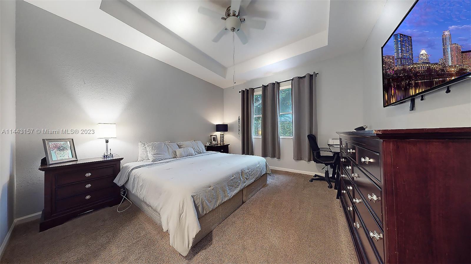 2231 Northeast 37th Road Homestead, FL 33033 - Photo 20 of 49 a bedroom with a bed and a chandelier