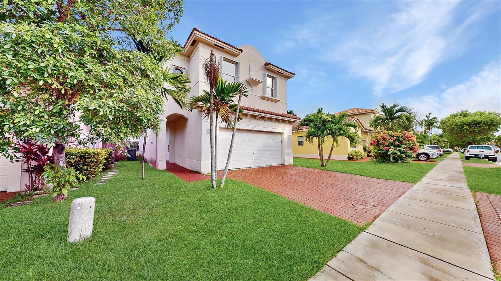 2231 Northeast 37th Road Homestead, FL 33033 - Photo 2 of 49 a front view of a house with garden