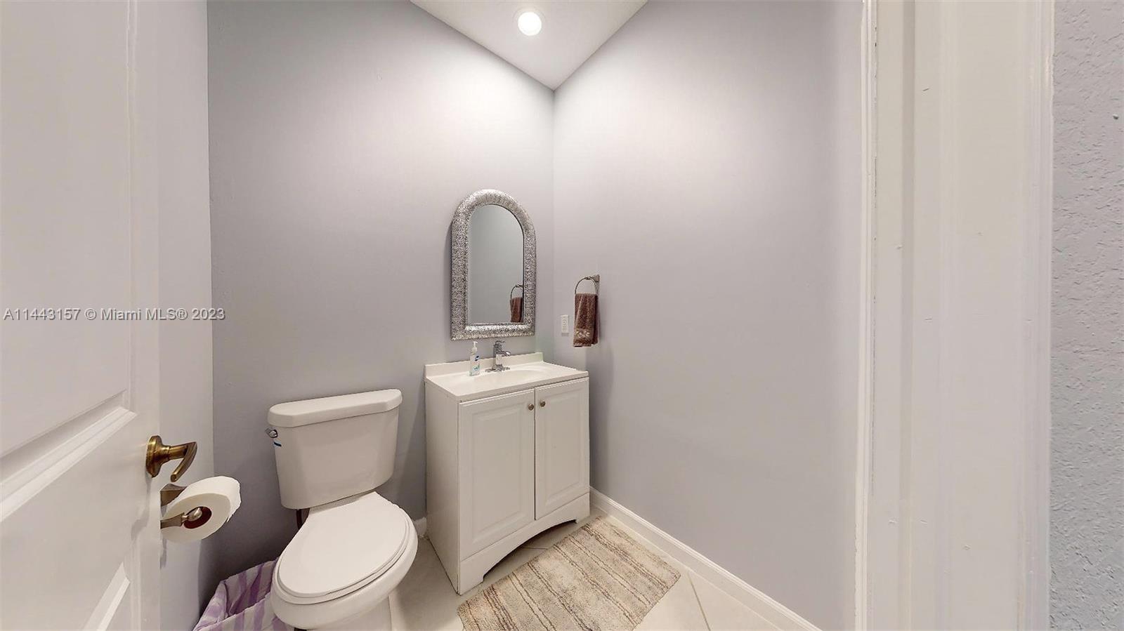 2231 Northeast 37th Road Homestead, FL 33033 - Photo 21 of 49 a white toilet sitting next to a bathroom sink