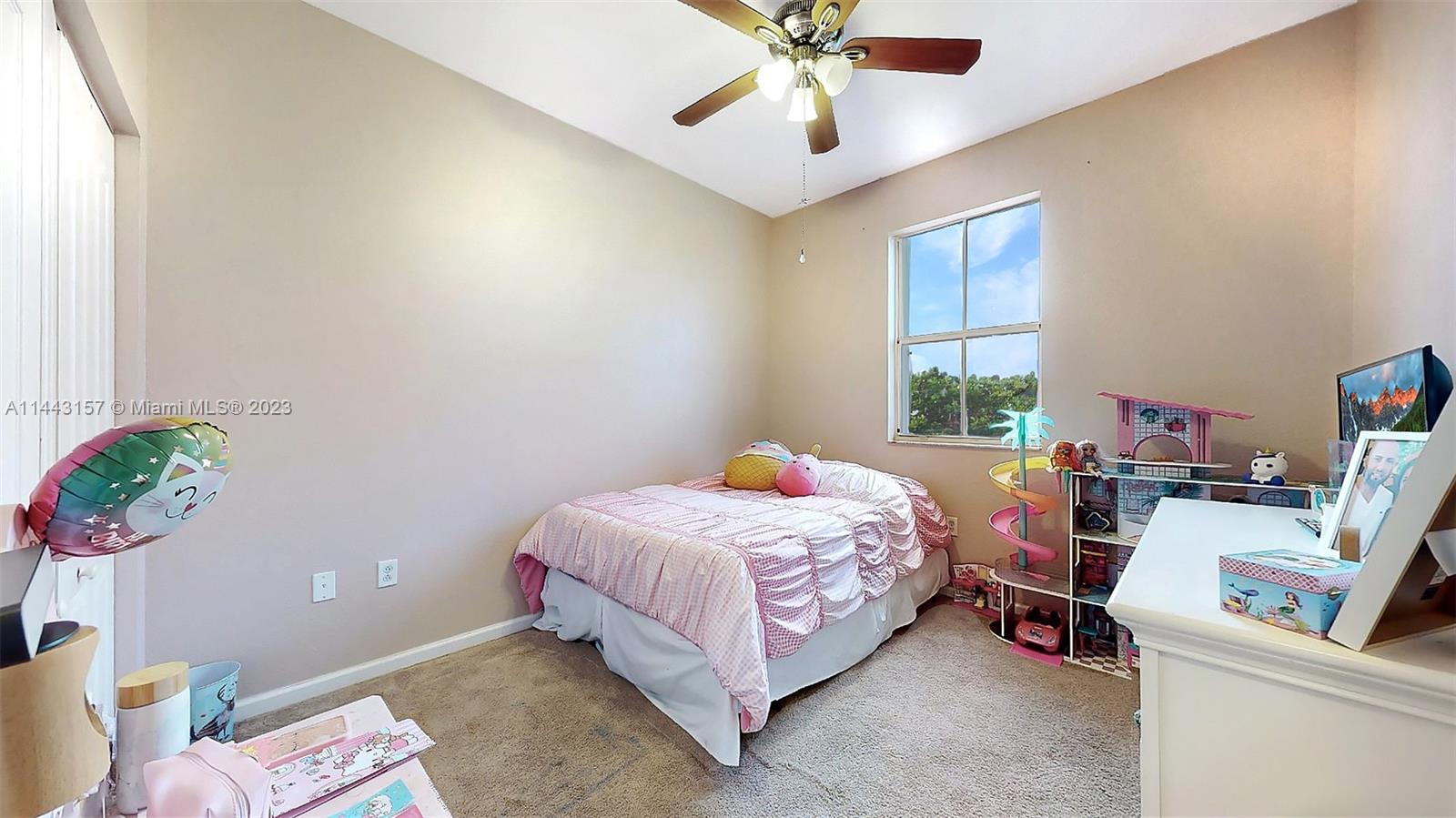 2231 Northeast 37th Road Homestead, FL 33033 - Photo 22 of 49 a bedroom with a bed and a chandelier