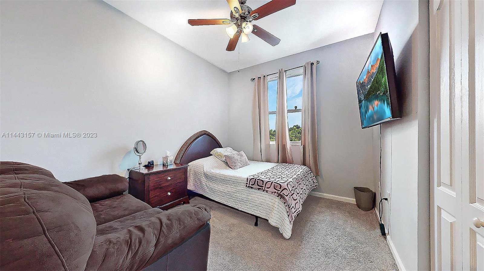 2231 Northeast 37th Road Homestead, FL 33033 - Photo 23 of 49 a bedroom with bed couch and window