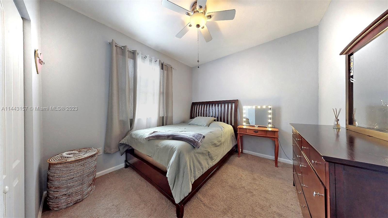 2231 Northeast 37th Road Homestead, FL 33033 - Photo 24 of 49 a bed room with a bed and a chandelier