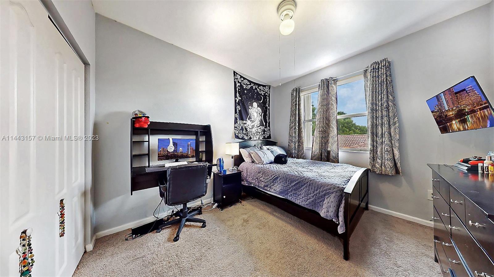 2231 Northeast 37th Road Homestead, FL 33033 - Photo 25 of 49 a bedroom with a bed and a chair
