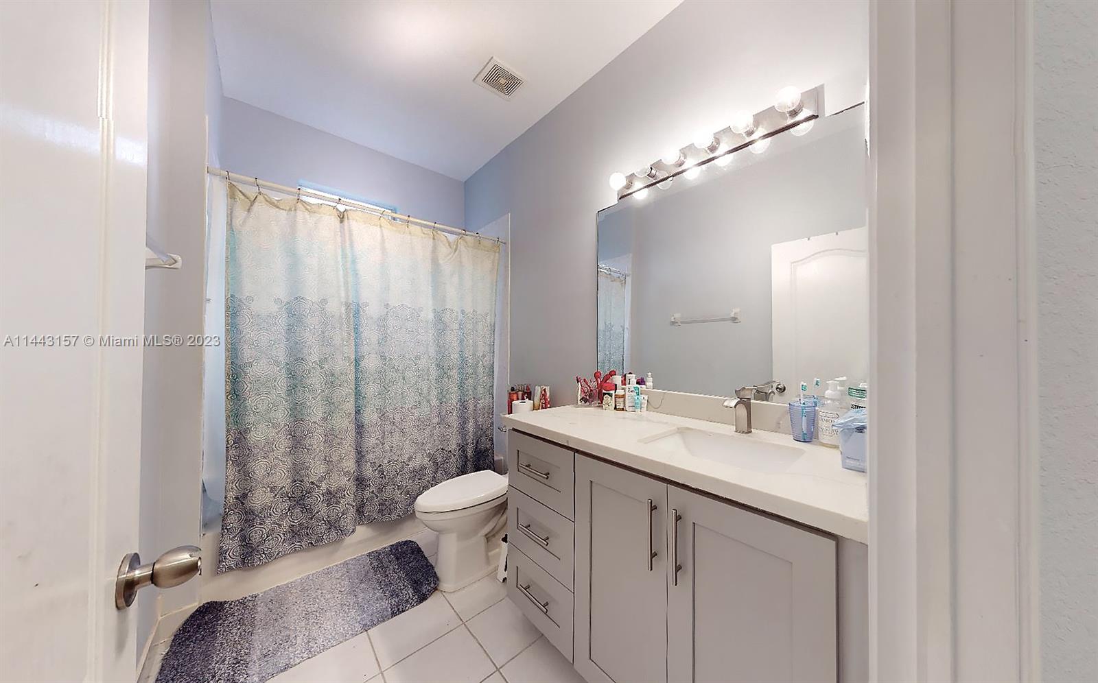 2231 Northeast 37th Road Homestead, FL 33033 - Photo 27 of 49 a bathroom with a double vanity sink toilet and shower