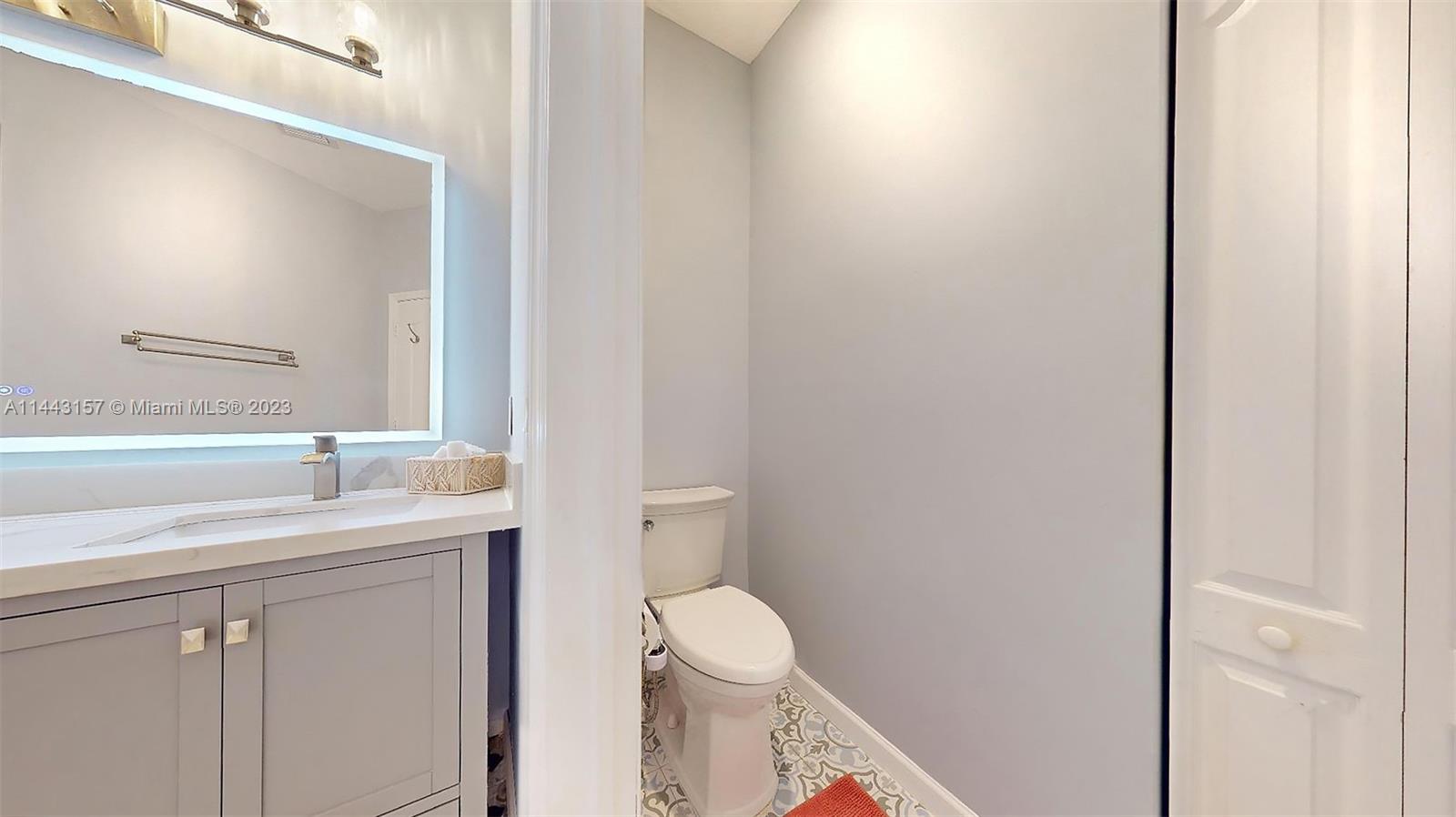 2231 Northeast 37th Road Homestead, FL 33033 - Photo 29 of 49 a bathroom with a toilet a sink and mirror