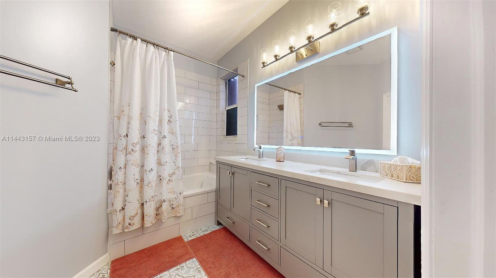 2231 Northeast 37th Road Homestead, FL 33033 - Photo 30 of 49 a spacious bathroom with a double vanity sink a mirror and a shower