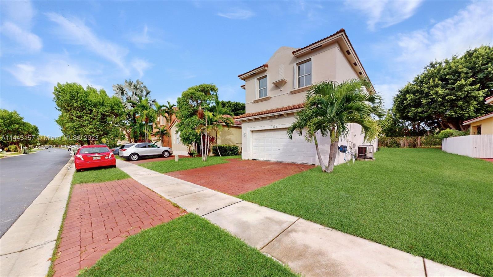 2231 Northeast 37th Road Homestead, FL 33033 - Photo 3 of 49 a front view of a house with a yard and garage