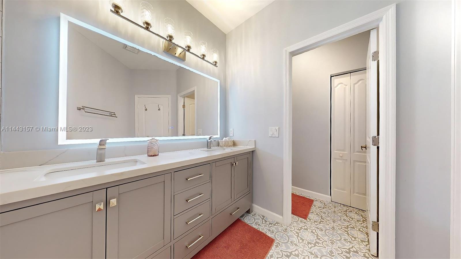 2231 Northeast 37th Road Homestead, FL 33033 - Photo 31 of 49 a spacious bathroom with a granite countertop sink a toilet and a mirror