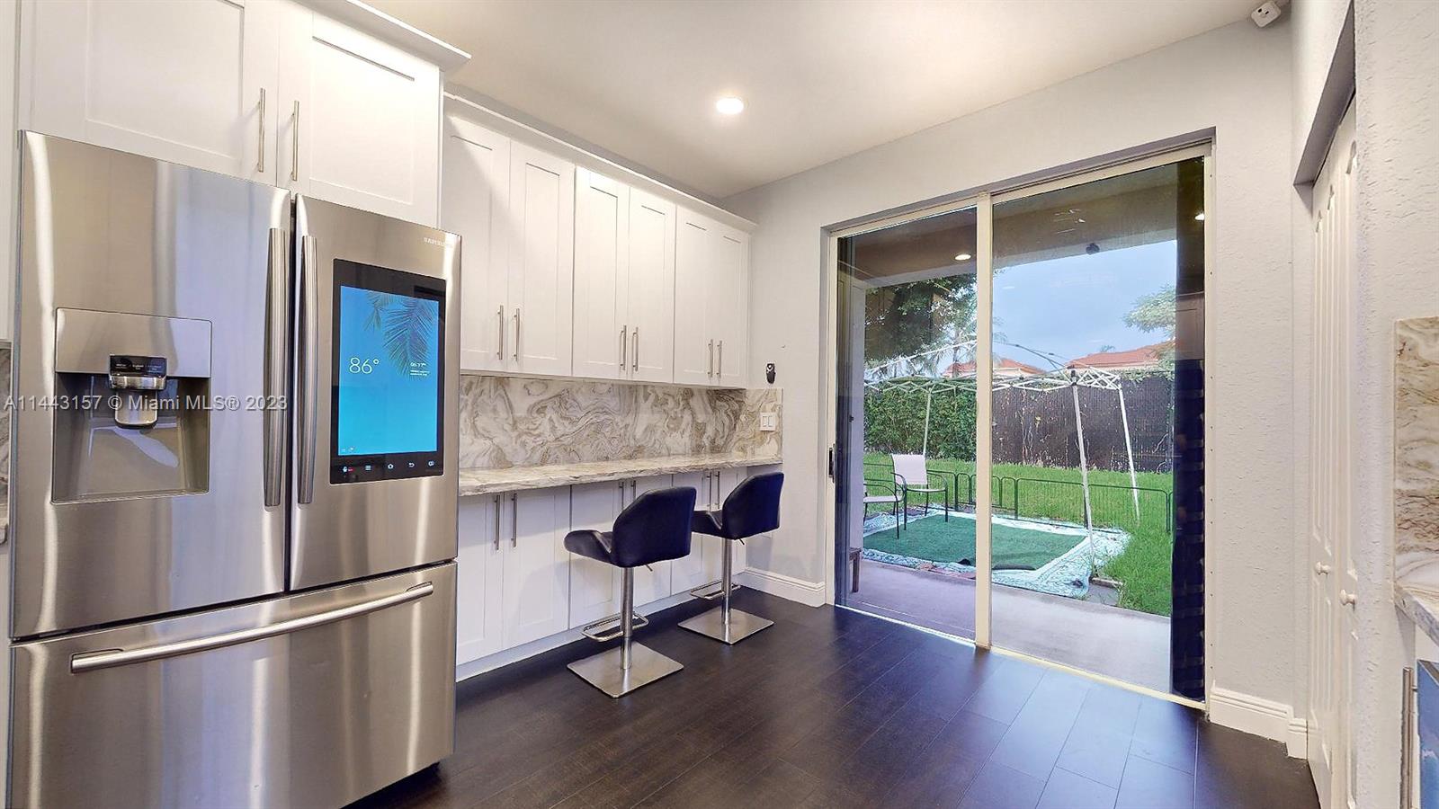 2231 Northeast 37th Road Homestead, FL 33033 - Photo 9 of 49 a kitchen with appliances and a wooden floor