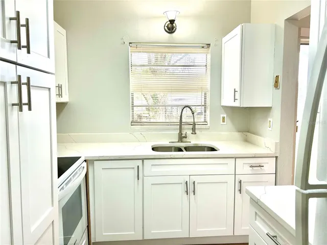 a kitchen with stainless steel appliances a sink and a window