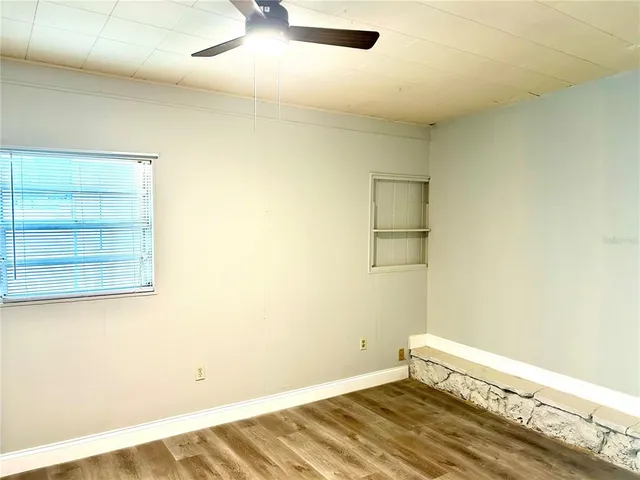 a view of a room with wooden floor and cabinet