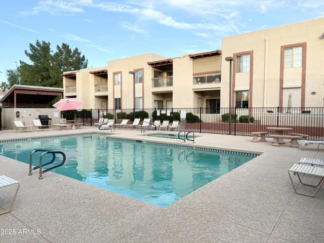 a view of a swimming pool with outdoor seating