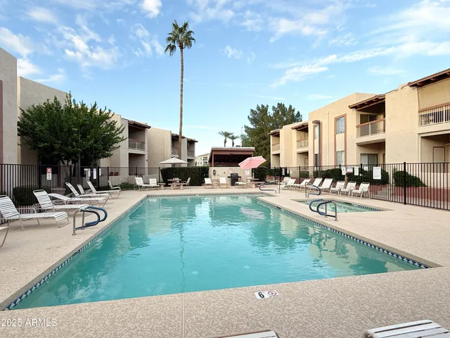 a swimming pool with outdoor seating and yard