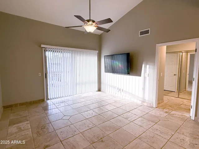 a view of a livingroom with a ceiling fan and window